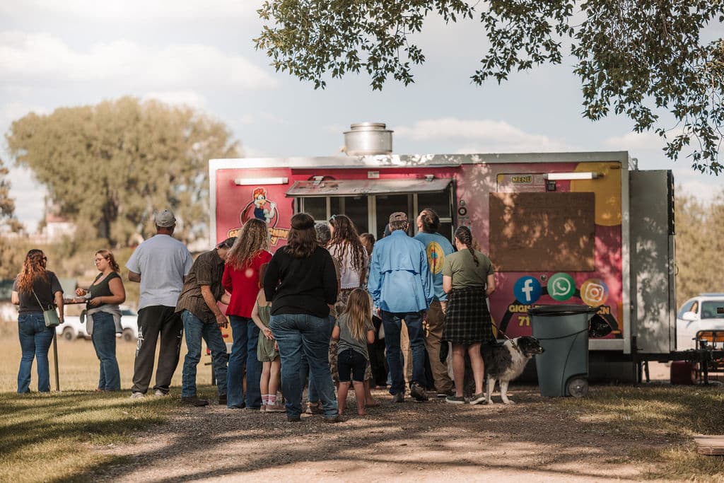 Guests lined up at a food truck on the ranch grounds during Locals Night