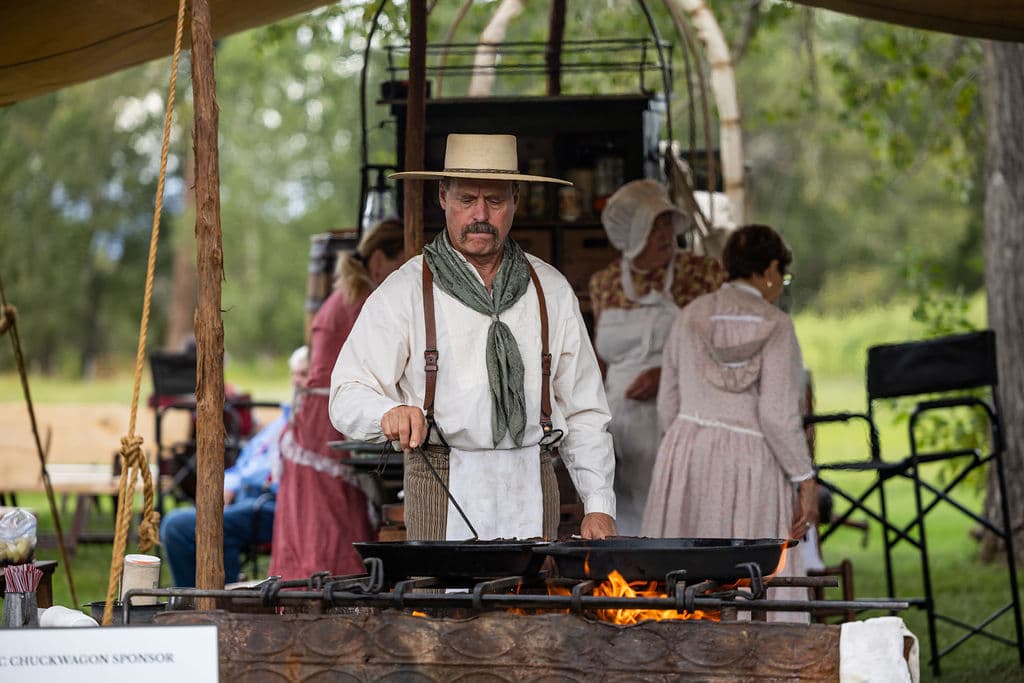 Chuckwagon cooking crew preparing food over an open fire