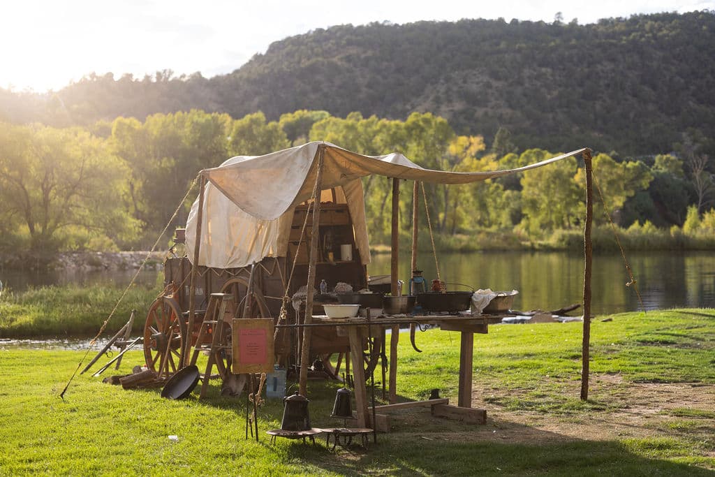 Historic chuckwagon camp beside the pond at golden hour