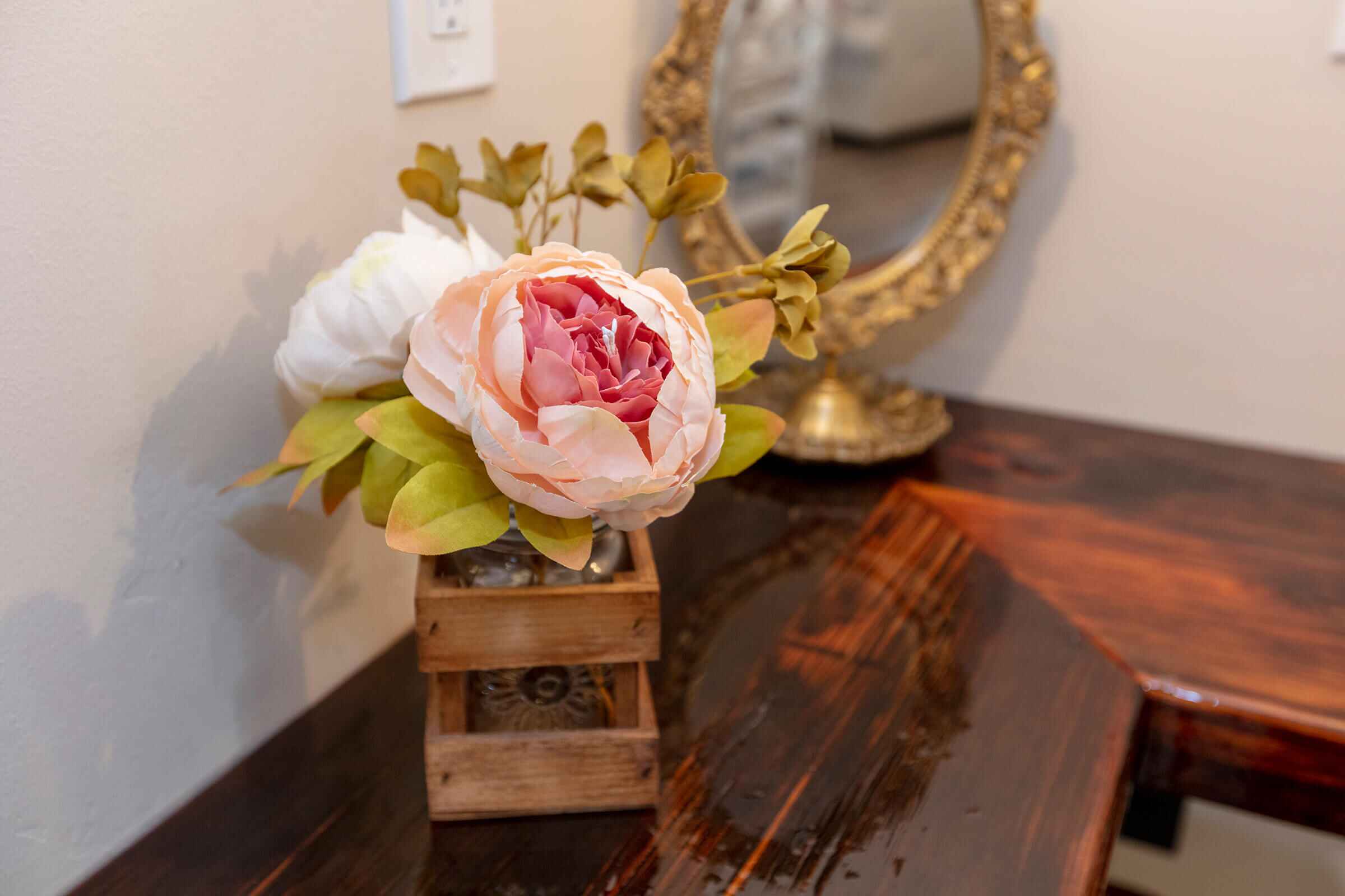 Peony arrangement and ornate gold mirror on The Loft vanity bar