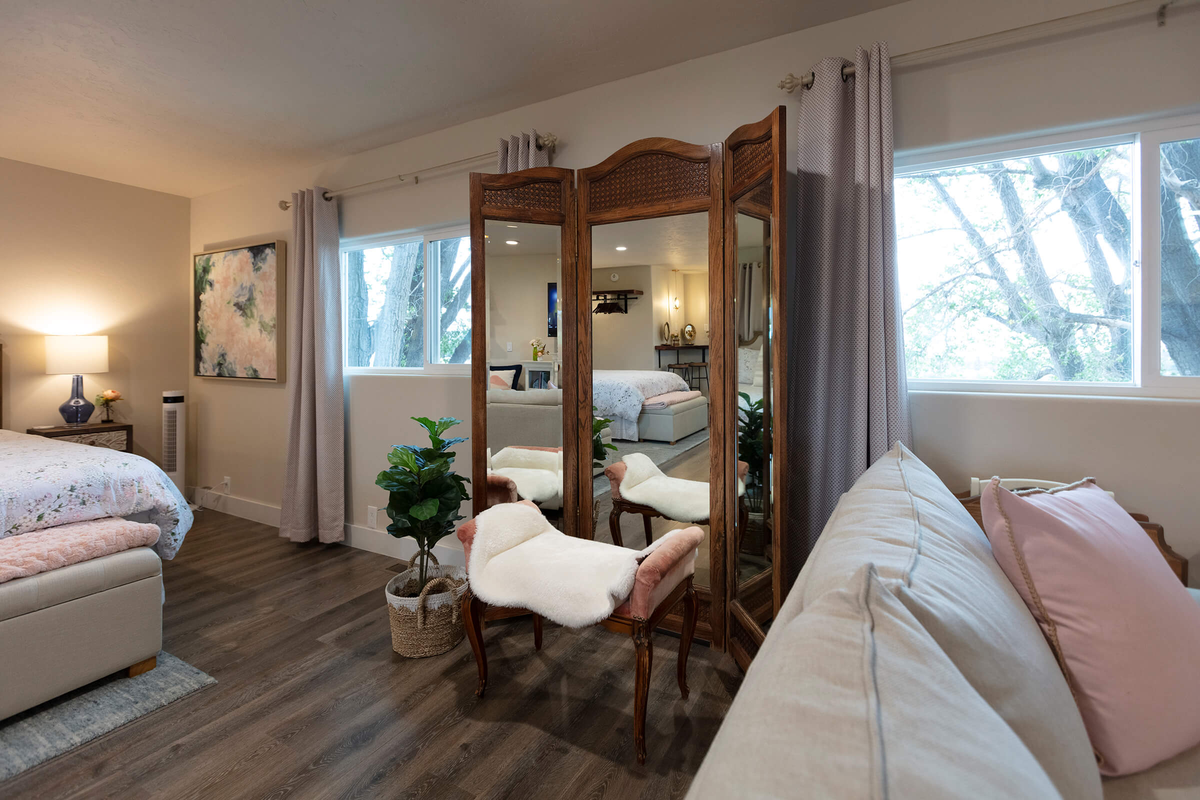 Wooden tri-fold mirror with vintage French chair and sheepskin throw in The Loft