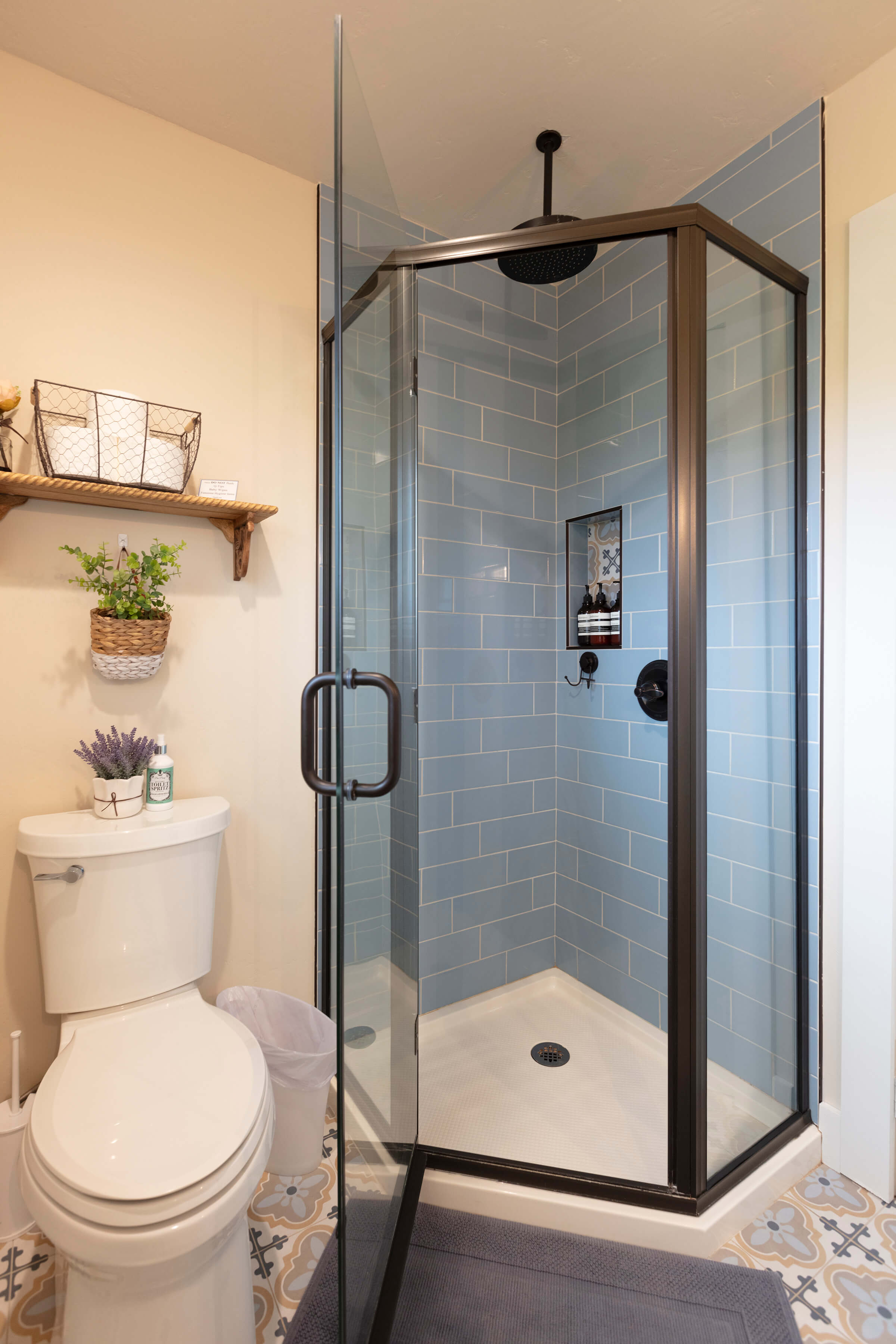 The Loft corner walk-in shower with blue subway tile and rainfall showerhead