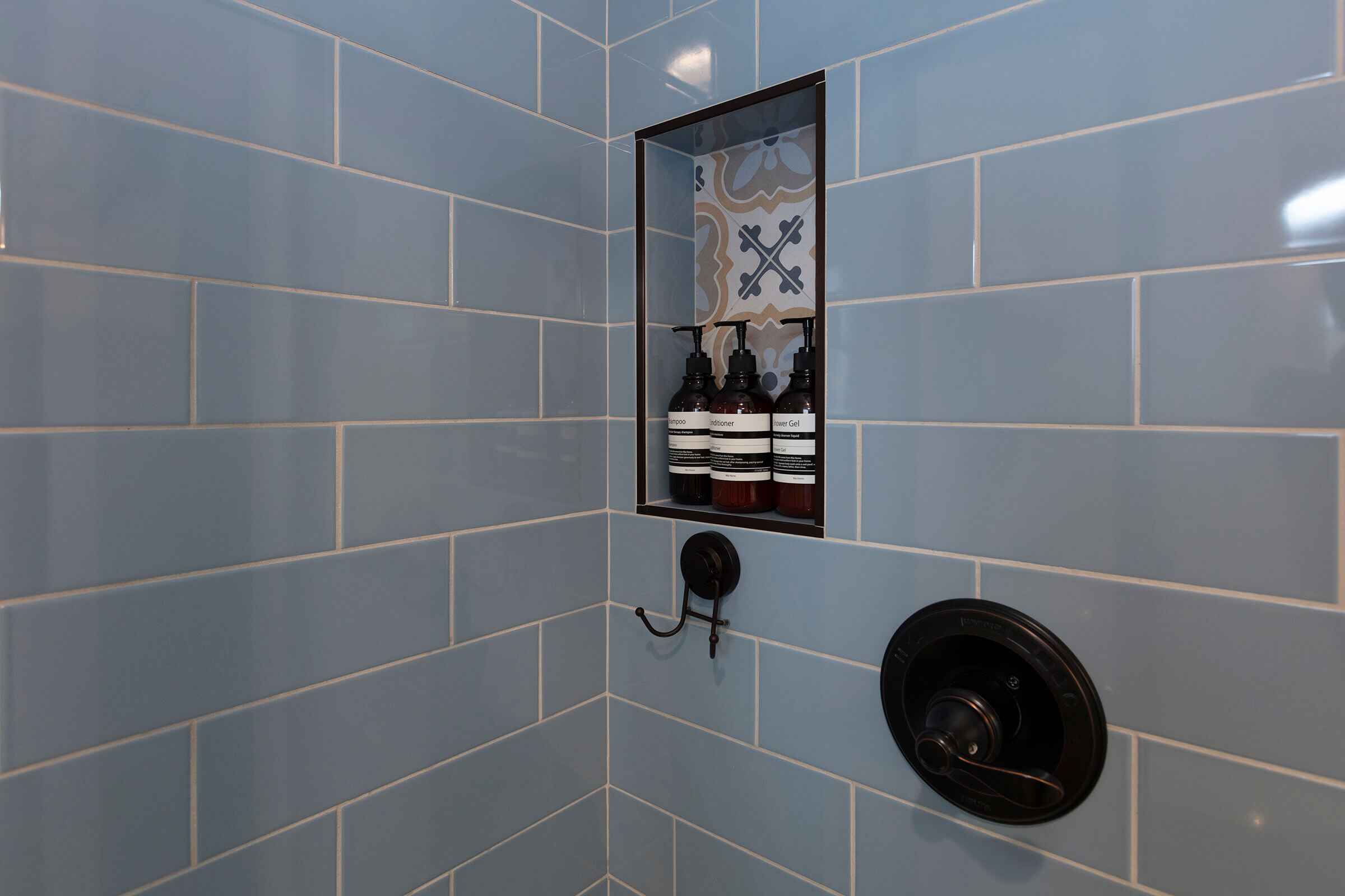 The Loft blue subway tile shower with premium toiletries